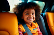 Smiling black child in a car seat buckled into a child seat. safety