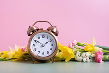 Alarm Clock With Spring Flowers. Spring Time, Daylight Savings Concept, Spring Forward