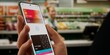 © ivanbaranov - Caucasian male using his smartphone wallet to pay using card connected to phone