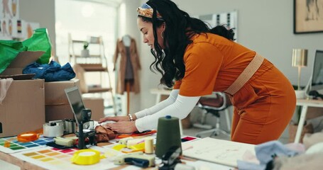 Wall Mural - Designer woman, laptop and typing in warehouse with color sample, check and ideas at fashion startup. Girl, clothes and fabric with computer for production, creativity and thinking at small business