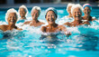 © Thijs - Senior woman lifting her arms in aqua fitness class in a swimming pool