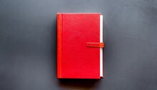 Red Closed Book With Blank Hard Cover On Background Top View Space For Text
