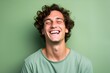 Caucasian Male Model Laughing. Isolated on a plain green background. Generative AI.