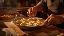 An Experienced Chef's Floured Hands Create A Symphony Of Flavors In Homemade Ravioli On The Rustic Kitchen Table.