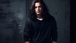 © Nemanja - A handsome good-looking young man with long black hair smiling, studio shot close up model photography, gray textured wall background. Wearing black hoodie