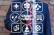 Doctor using virtual touch screen sees inscription: GRANT FUNDING. Concept of healthcare grants funding. Medical Innovation Education Grant Fund Application Donation.