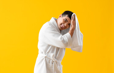 Poster - Handsome man wiping hair after washing on yellow background