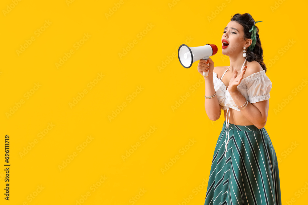 Attractive pin-up woman shouting into megaphone on yellow background