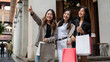 Group of fun Asian girl friends are enjoying shopping in the city during their abroad trip together.