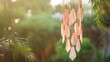 Pastel peach wind chimes hanging in a garden, copy space, summer mood