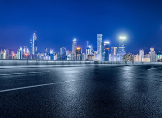 Wall Mural - Asphalt road and modern city buildings at night in Shenzhen, China.