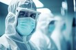 Surgeon in protective suit and mask working in operating room at hospital
