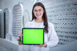 © APchanel - Doctor optical professional working check quality of glasses in optical shop by see detail on  tablet is optical clinic business concept.