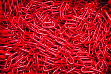 A Bunch Of Red Chains Close-up. Texture And Background Of Chains.