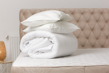 Poster - Soft folded duvet and pillows on bed
