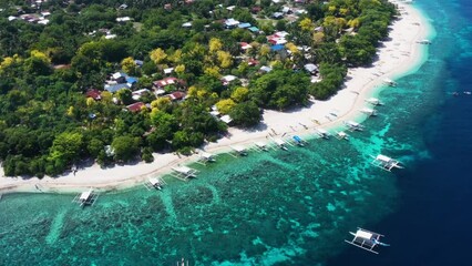 Wall Mural - traveling in drone shot of island beach in the philippines with boats and local houses 
