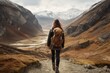 Young woman with backpack hiking in the mountains. Travel and adventure concept, A female hiker walking in the mountains, no visible faces, natural background, AI Generated