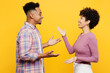 © ViDi Studio - Side view young fun couple two friend family man woman of African American ethnicity wear purple casual clothes together talk speak look to each other meet isolated on plain yellow orange background