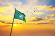 Waving flag of Macao against the background of a sunset or sunrise. Macao flag for Independence Day. The symbol of the state on wavy fabric.