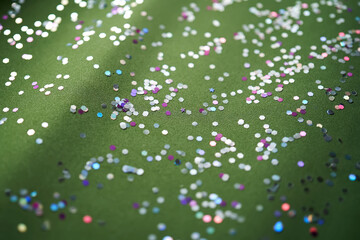 Wall Mural - snowflake shaped confetti on green velvet. christmas background.