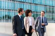 Business people meeting in a business park - Corporate businessmen and businesswoman bonding outdoors, colleagues meeting after work