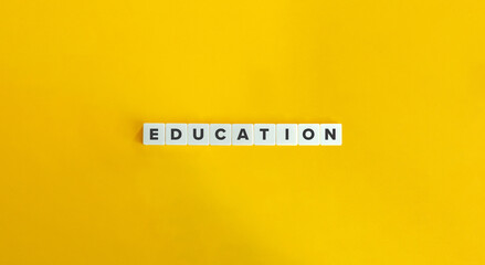 Wall Mural - education word on block letter tiles on yellow background. minimalist aesthetics.