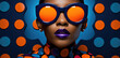 © Sascha - Vibrant portrait of a woman in oversized orange sunglasses with a vivid purple lipstick against a dotted blue background, showcasing modern fashion and bold style choices.