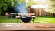 © ROKA Creative - Summer time in backyard garden with grill BBQ, wooden table, blurred background