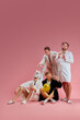 © master1305 - Handsome men in bathrobes doing beauty procedures, shaving legs, painting nails, applying face mask against pink background. Concept of leisure activity, fun, bachelor party, friendship, home spa