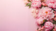 Flowers composition with roses and peonies on flat lay light pink background with copy space