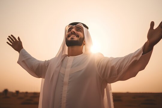 a young saudi muslim man raising arms to the sky to pray in the wilderness. peaceful, tranquil, ethereal light, sunset. generative AI