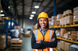 © Simon - Happy and confident African American female worker wearing safety helmet smiling at camera while standing in factory.