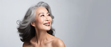 Korean Woman Face With Smooth Healthy Neckline Skin. Korean, Chinese Asian Beautiful Aging Years Old, Young Looking Smiling Woman, Beauty Health Skincare And Cosmetics Advertising Concept