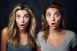 Two shocked girl friends staring in disbelief