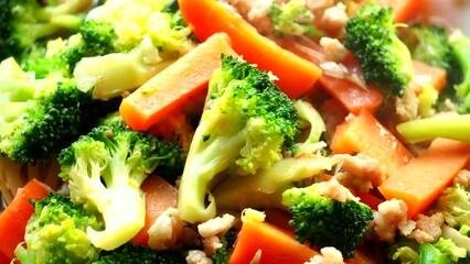 Wall Mural -  Frying broccolis and carrots in pan, in door  Chiangmai  Thailand.