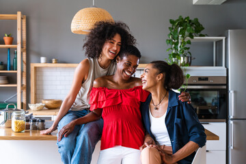 Wall Mural - Beautiful and cheerful black and hispanic adult woman bonding and having fun at home