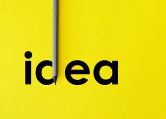 Poster - The word Idea is shown using composition with grey pencil isolated on yellow paper that look minimalist. Creative thinking used for presentations in the field of education, business or creativity
