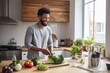 Muscular handsome african american man make breakfast from healthy food and vegetables in the kitchen at home .
