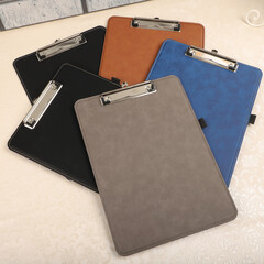 Colorful leather clipboard. Genuine leather clipboard, concept shot, top view, different color, clamshell and stitched clipboard