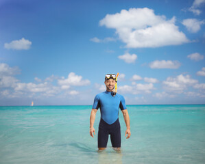 Wall Mural - Man wearing a diving suit and mask and standing into the water