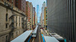 Train traveling toward Trump Tower, tourism with downtown skyscraper buildings, Chicago aerial