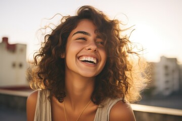 Canvas Print - A woman with curly hair smiling at the camera. Perfect for showcasing joy and happiness in various projects