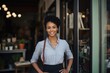 © Vorda Berge - Portrait of a female small business owner standing in front of her establishment