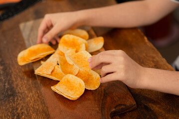 Wall Mural - Playtime with snacks: child's game of chip stacking during snack break.