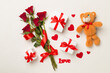 Red rose flowers with gift box and soft toy on concrete background, top, view. Valentine's day concept