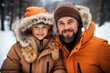 © Georgii - Happy Caucasian tourist family in winter outwear posing against the backdrop of snowy forest. Cheerful father and his beautiful daughter spend winter vacation together.