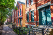 Rent, mortgage, refinance, house, home or apartment with teal doors in inner city neighborhood