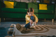 © Miljan Živković - girl toddler child puts on her own boots in the winter at home