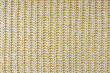 Jersey textile background , yellow white melange knitted wool fabric. Woolen knitwear, sweater, pullover surface texture, textile structure, cloth surface, weaving of knitwear material