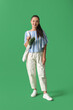 © Pixel-Shot - Young Asian woman with eco bag full of fresh food on green background